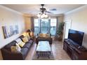 Living room with gray sofas, a coffee table, and a view from large windows at 914 Charo Pkwy # 114, Davenport, FL 33897