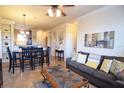 Open concept living and dining area with gray sofas and a dining table at 914 Charo Pkwy # 114, Davenport, FL 33897