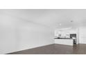 Modern kitchen with stainless steel appliances and gray tile floors at 450 Lake Shore Pkwy, Davenport, FL 33896
