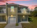 Two-story townhome with attached garage and balcony at 450 Lake Shore Pkwy, Davenport, FL 33896