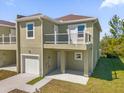 Two-story townhome with attached garage and balcony at 450 Lake Shore Pkwy, Davenport, FL 33896