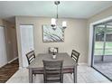 Bright dining room with a four-chair table and access to the backyard at 3220 Chariot Pl, Orlando, FL 32818