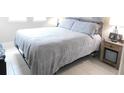 Spacious bedroom with gray bedding and nightstand at 5430 Nw 34Th St, Ocala, FL 34482