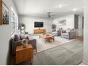 Living room with gray sofas, a coffee table, and a large TV at 46 Columbine Trl, Debary, FL 32713