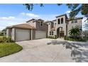 Large home with a three-car garage and circular driveway at 6019 Linneal Beach Dr, Apopka, FL 32703