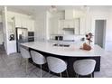 Modern kitchen with white cabinets, large island, and stainless steel appliances at 4749 Riverwalk Dr, St Cloud, FL 34771
