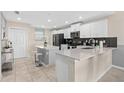 Modern kitchen with white cabinets and quartz countertops at 3131 Paradox Circle 204 # 204, Kissimmee, FL 34746