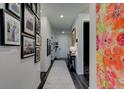 Bright foyer with hardwood floors, gallery wall, and large floral art at 4009 Winding Meadows St, Apopka, FL 32712