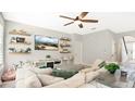 Spacious living room with large sectional sofa and built-in shelving at 521 Morgan Wood Dr, Deland, FL 32724