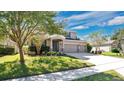 Two-story house with a three-car garage and beautifully landscaped yard at 521 Morgan Wood Dr, Deland, FL 32724
