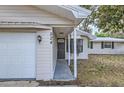 Front entry with walkway leading to the garage at 524 E Church St, Deland, FL 32724