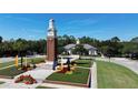 Community center with a clock tower and landscaped grounds at 14494 Whittridge Dr, Winter Garden, FL 34787