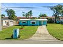 Ranch-style home with light blue siding and a well-maintained lawn at 2669 Anastasia Dr, South Daytona, FL 32119