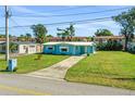 Ranch-style home with light blue siding and a well-maintained lawn at 2669 Anastasia Dr, South Daytona, FL 32119