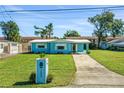Ranch-style home with light blue siding and a well-maintained lawn at 2669 Anastasia Dr, South Daytona, FL 32119