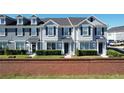 Two-story townhouses with gray siding, dark gray roofs, and landscaping at 643 Underwood Cv, Casselberry, FL 32707