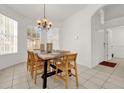 Bright dining room with large table and chandelier at 416 Calabay Parc Blvd, Davenport, FL 33897