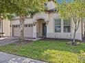 Two-story home with a two-car garage and manicured lawn at 8832 Macapa Dr, Kissimmee, FL 34747