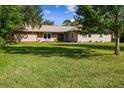 Single-story home with large green lawn and mature trees at 1735 Tanglewood Dr, Kissimmee, FL 34746