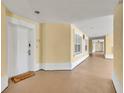 Bright hallway with light walls and tiled floors at 7659 Whisper Way # 102, Reunion, FL 34747
