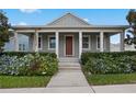 Gray craftsman style home with front porch and landscaped yard at 6275 Hamlin Reserve Blvd, Winter Garden, FL 34787