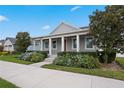 Gray craftsman style home with front porch and landscaped yard at 6275 Hamlin Reserve Blvd, Winter Garden, FL 34787