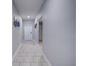 Clean hallway with tile flooring and neutral wall colors at 168 Taft Dr, Davenport, FL 33837