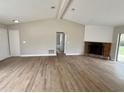 Living room with a stone fireplace and view to backyard at 6225 Centennial Dr, Orlando, FL 32808