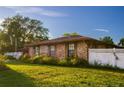 Brick home with a large yard and white fence at 1159 Collins Ave, Orange City, FL 32763