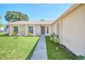 Brick house with a walkway, landscaping and a door at 2204 Clementine Trl, Clermont, FL 34714