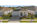 Single-story home with gray exterior, gray roof, and a covered front porch at 2071 Limestone Trl, Kissimmee, FL 34747