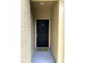 Condo entryway with a black door and a welcome mat at 413 Summit Ridge Pl # 209, Longwood, FL 32779