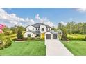 Two-story house with a three-car garage, and landscaping at 4001 Ainsley Ave, Orlando, FL 32833