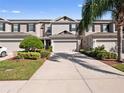Two-story townhome with attached garage and driveway at 1936 Compass Flower Way, Ocoee, FL 34761