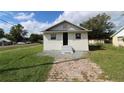 Cute bungalow home with a brick walkway and well-maintained lawn at 828 Willie Mays Pkwy, Orlando, FL 32811