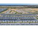 Aerial view of a new home community with modern townhouses and a private pool at 730 Drop Shot Dr, Davenport, FL 33896