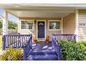 Front porch with purple railings, pumpkins, and potted plants at 1618 Coletta Dr, Orlando, FL 32807