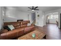 Spacious living room with leather sectional and hardwood floors at 2935 Aein Rd, Orlando, FL 32817