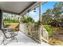 Front porch with wooden bench and views of backyard at 2935 Aein Rd, Orlando, FL 32817