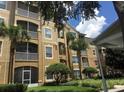 Exterior of a three-story condo building with balconies and landscaping at 2484 San Tecla # 303, Orlando, FL 32835
