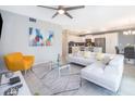 Open living room featuring white sectional sofa and stylish decor at 4721 Clock Tower Dr # 207, Kissimmee, FL 34746