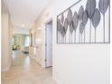 Bright hallway with tile floors and access to living areas at 4721 Clock Tower Dr # 207, Kissimmee, FL 34746
