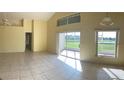 Bright living room with tile floors and access to patio at 2688 Hawthorne Ln, Kissimmee, FL 34743