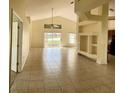 Spacious living room with tile floors and access to a patio at 2688 Hawthorne Ln, Kissimmee, FL 34743