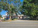 Two story home with large yard, driveway, and mature trees at 4715 Beach Blvd, Orlando, FL 32803