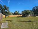 Vacant lot with wooden fence and grass at 4715 Beach Blvd, Orlando, FL 32803