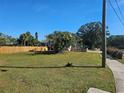 Vacant lot with grass and wooden fence at 4715 Beach Blvd, Orlando, FL 32803