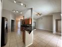 Open kitchen with breakfast bar, stainless steel appliances, and wood cabinets at 817 Highland Crest Loop, Lake Wales, FL 33853
