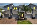 Modern three-unit townhome building with attached garages at 543 Ocean Course Ave, Davenport, FL 33896