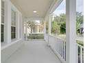 Spacious front porch overlooking a tree-lined street at 7041 Buttonbush Loop, Harmony, FL 34773